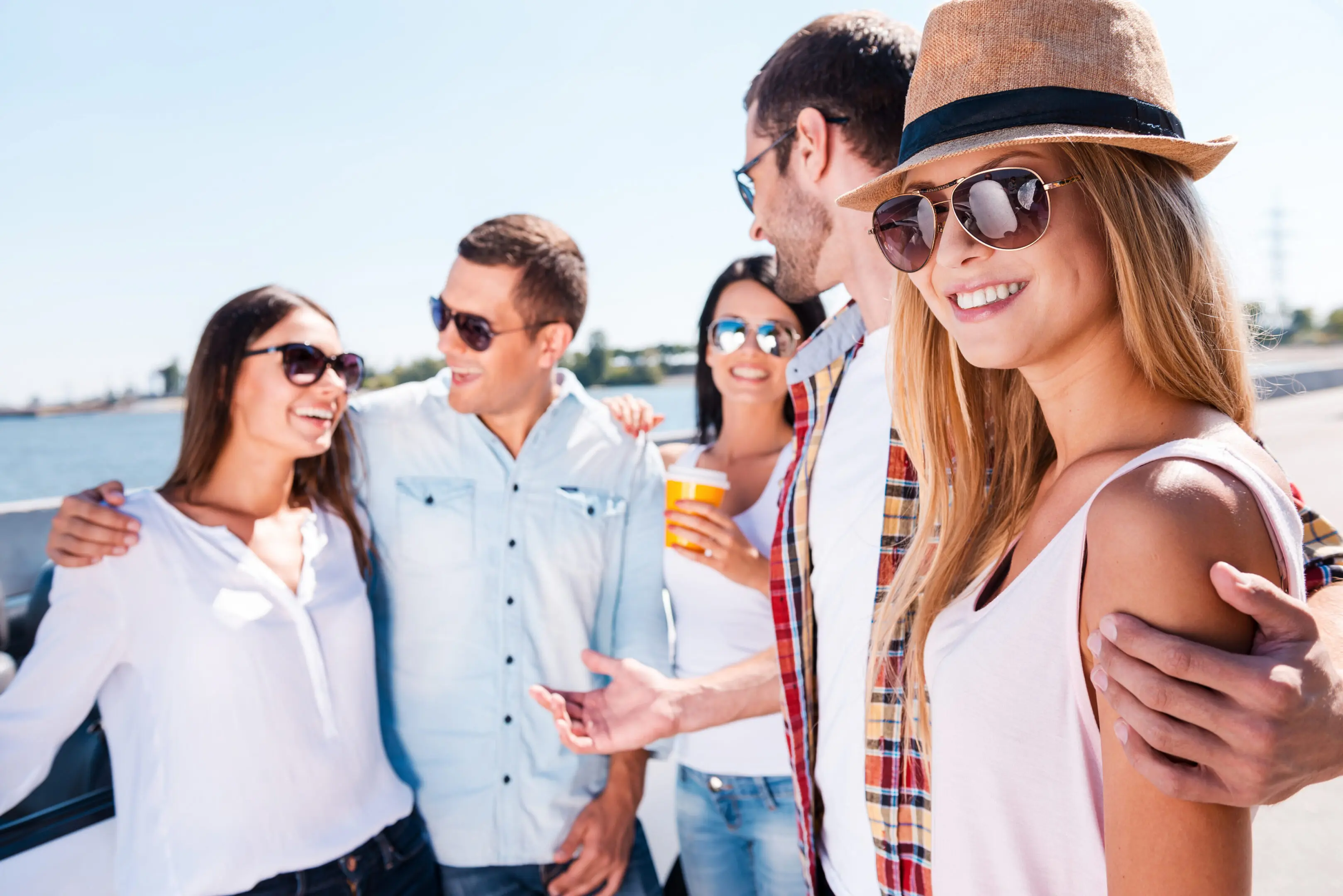 Group of friends standing on a boat, and enjoying each other's company