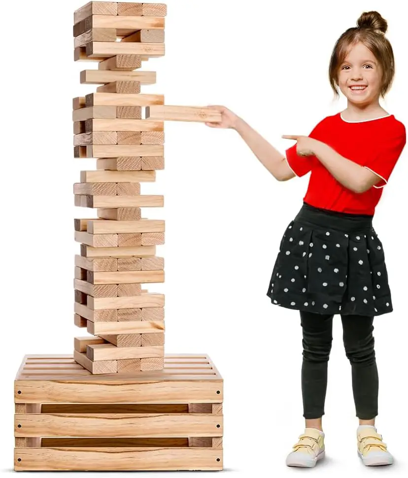 Little girl playing a game of Jenga on a wooden block tower
